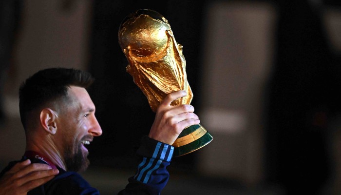 Where to see Lionel Messi holding the World Cup trophy? Find the iconic photo here!