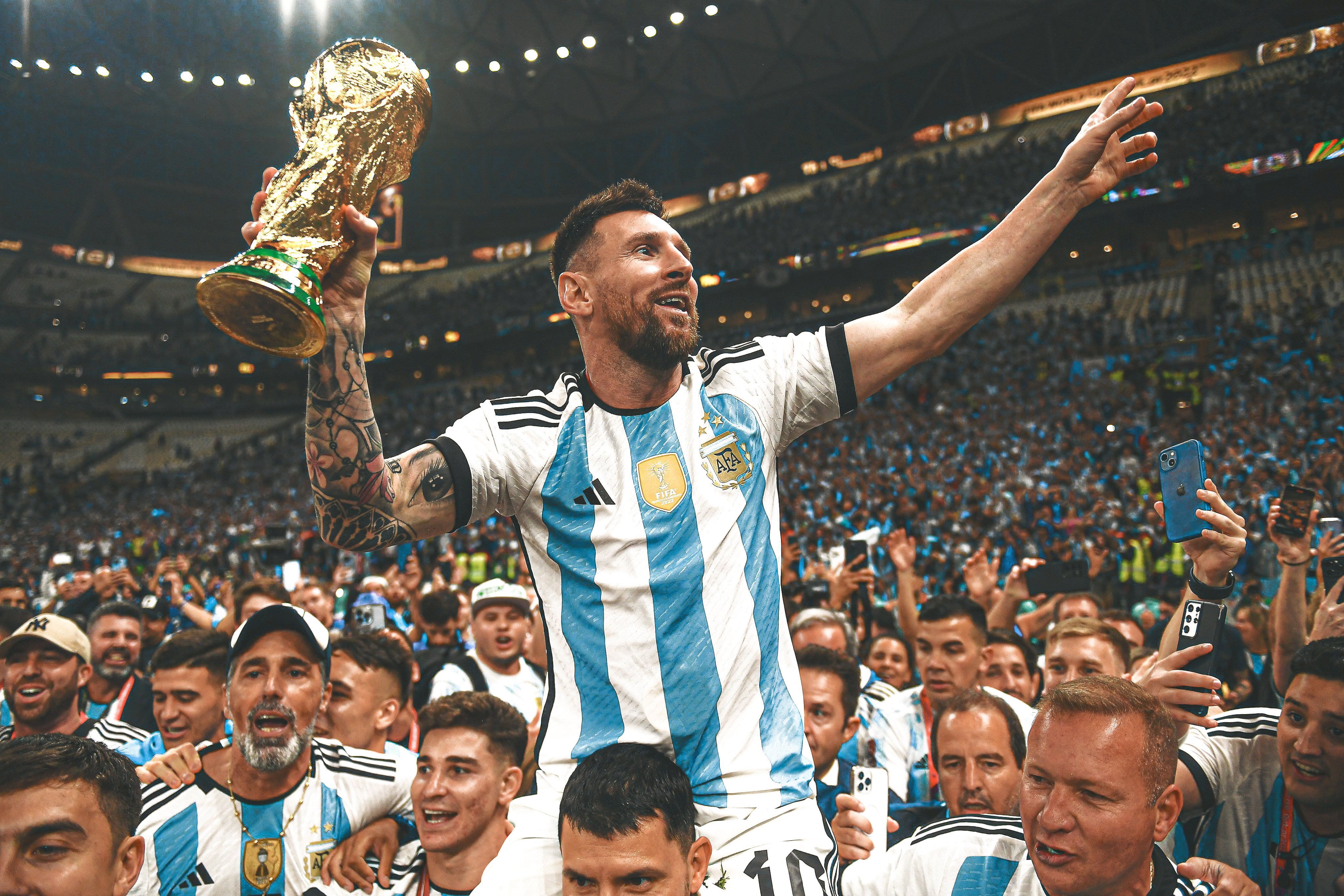 Where to see Lionel Messi holding the World Cup trophy? Find the iconic photo here!